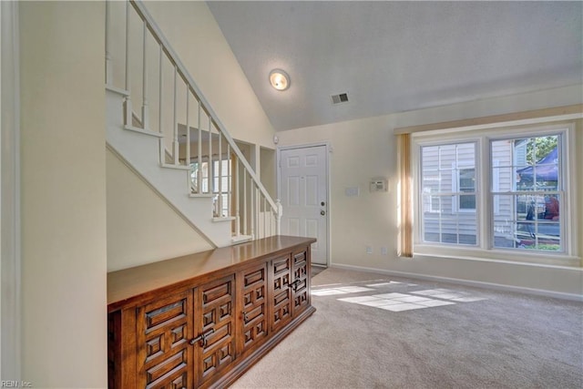 entryway featuring carpet and vaulted ceiling