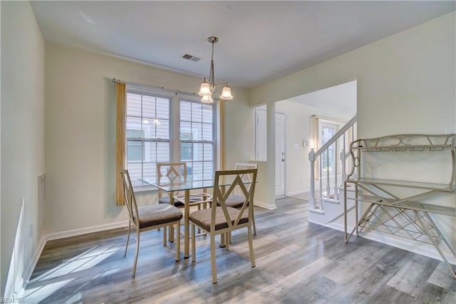 dining space featuring a chandelier and wood-type flooring