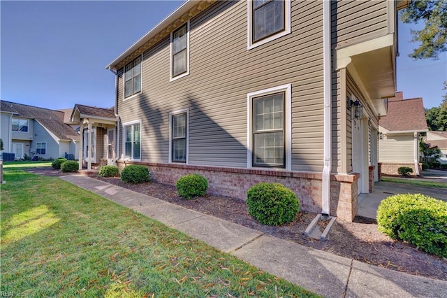 view of side of home featuring a yard