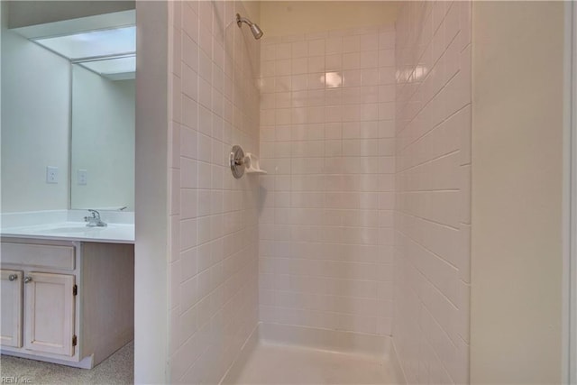 bathroom featuring vanity and a tile shower