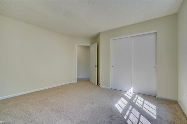 unfurnished bedroom featuring a closet and light carpet