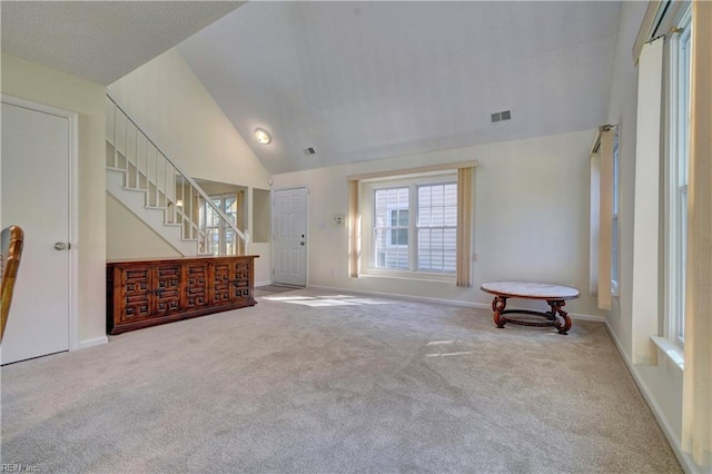 interior space featuring lofted ceiling and light colored carpet