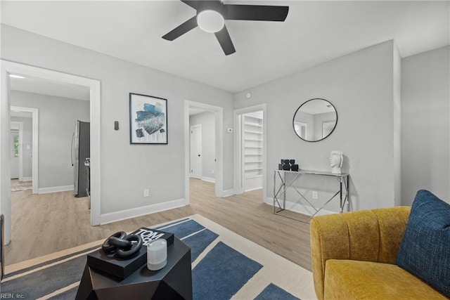 living room featuring ceiling fan and wood-type flooring