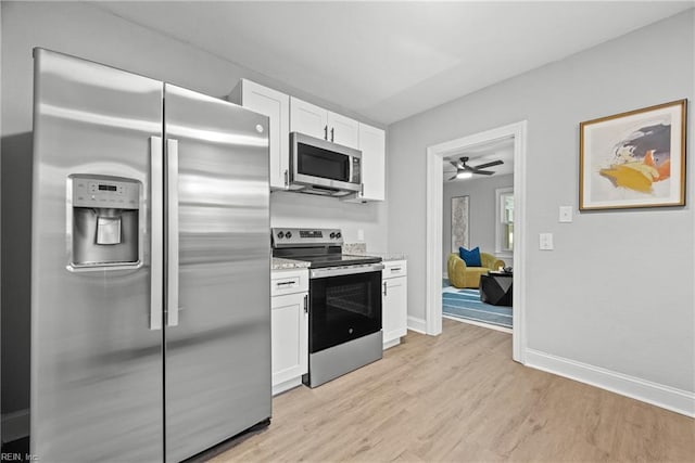 kitchen featuring appliances with stainless steel finishes, light stone countertops, ceiling fan, light hardwood / wood-style floors, and white cabinets