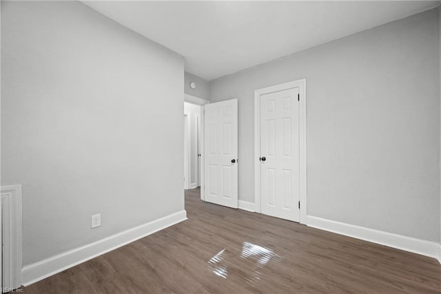 unfurnished bedroom featuring dark hardwood / wood-style floors