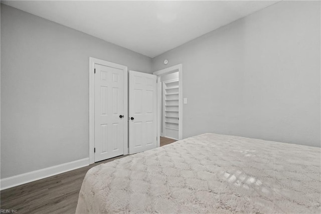 bedroom with dark wood-type flooring