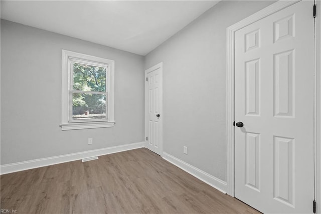 spare room featuring light hardwood / wood-style floors