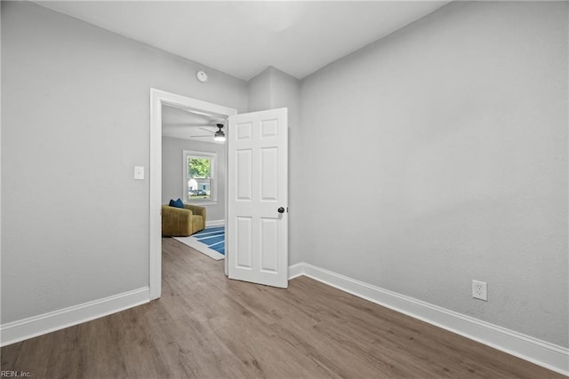 empty room featuring wood-type flooring and ceiling fan