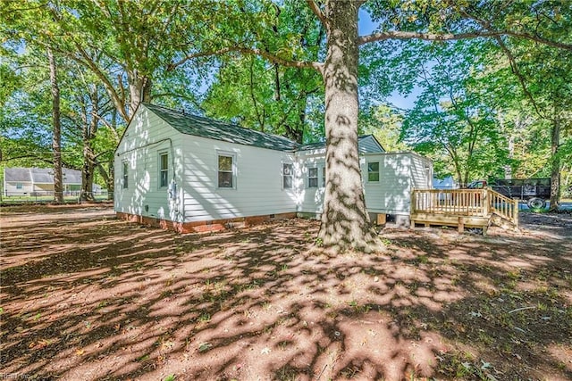 back of house with a wooden deck