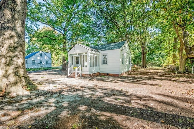 view of outbuilding featuring a sunroom