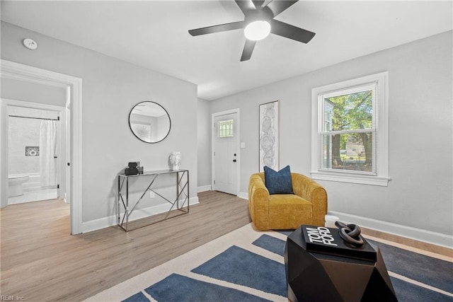 sitting room featuring hardwood / wood-style floors and ceiling fan