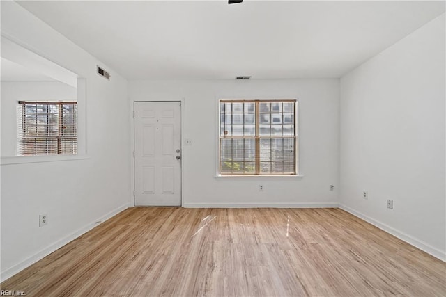 spare room with light hardwood / wood-style floors and a wealth of natural light