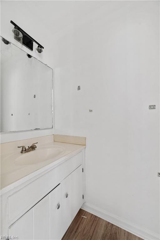 bathroom with vanity and hardwood / wood-style floors