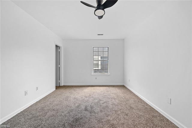 carpeted spare room featuring ceiling fan