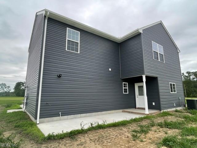 rear view of house featuring cooling unit