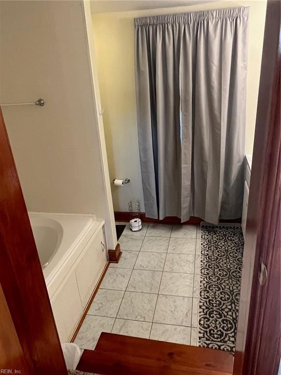 bathroom featuring a bathing tub and tile patterned flooring