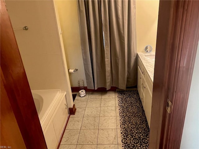 bathroom with vanity, a bathing tub, and tile patterned flooring