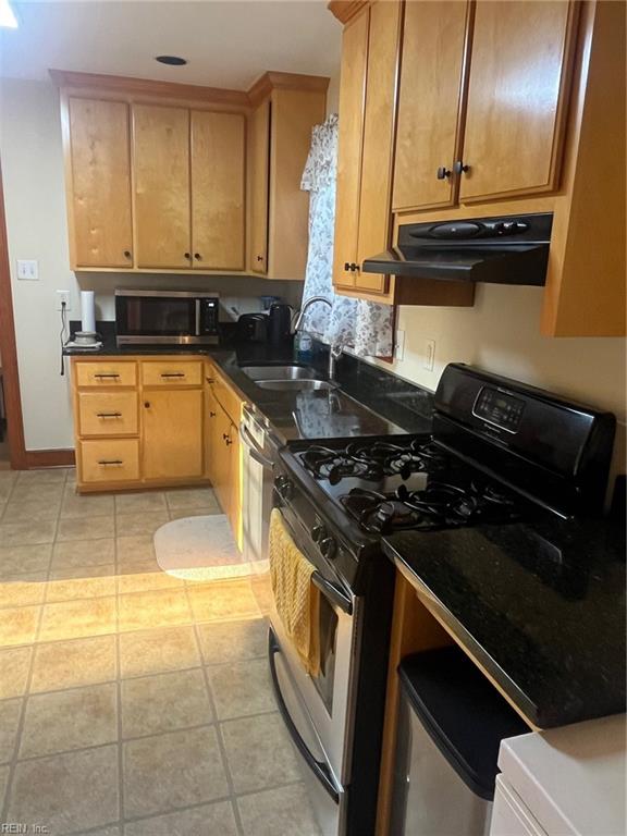 kitchen with sink, appliances with stainless steel finishes, and light tile patterned flooring