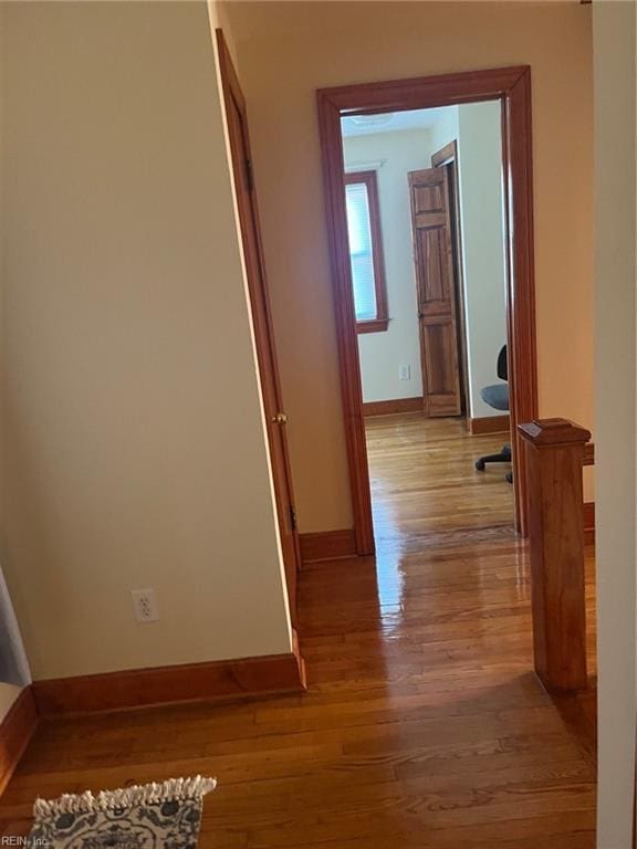 hallway with light hardwood / wood-style flooring