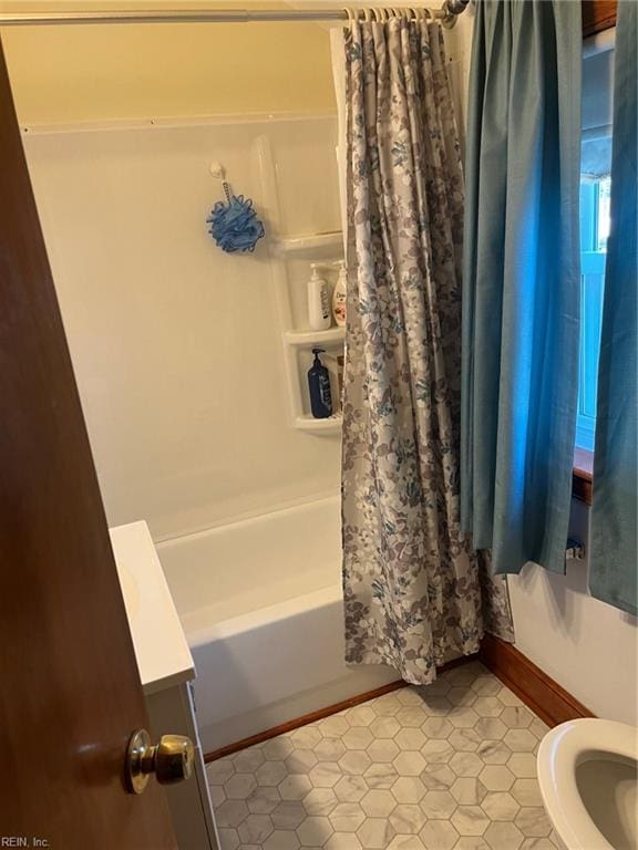 bathroom with toilet, tile patterned floors, and shower / bath combo