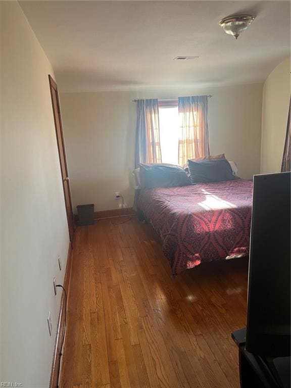 bedroom with hardwood / wood-style floors