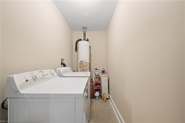 laundry room featuring water heater and washing machine and clothes dryer