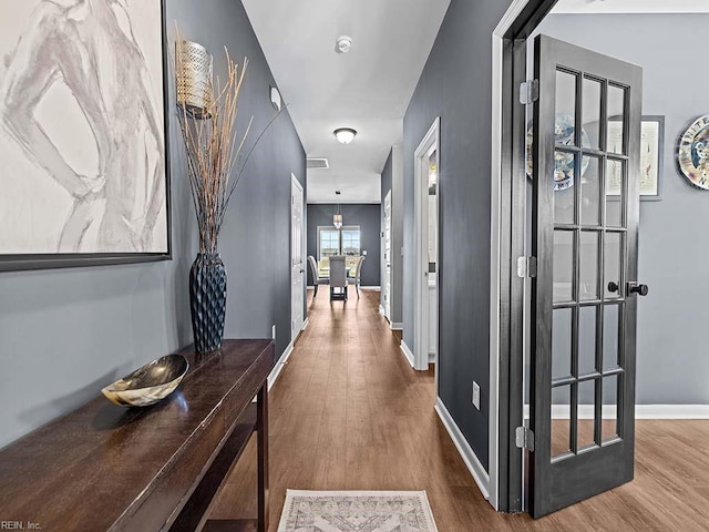 corridor with dark hardwood / wood-style flooring