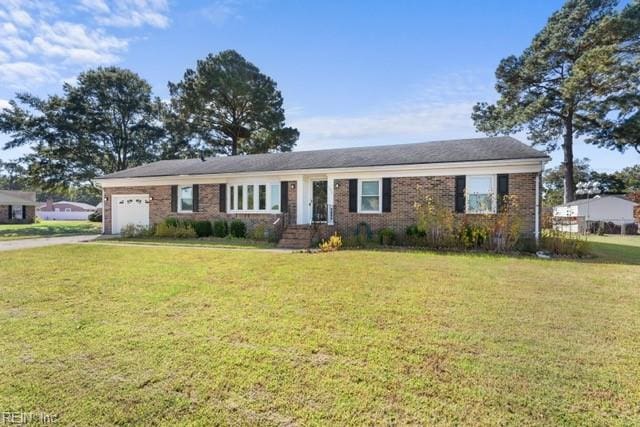 single story home featuring a garage and a front lawn