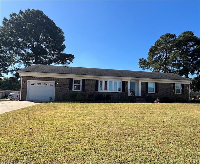 single story home featuring a garage and a front lawn