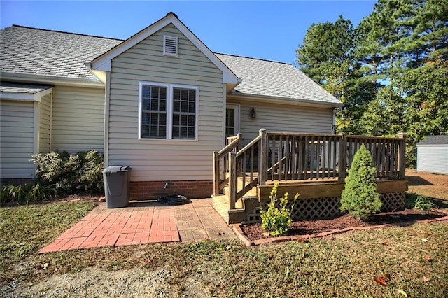 back of property with a patio and a wooden deck