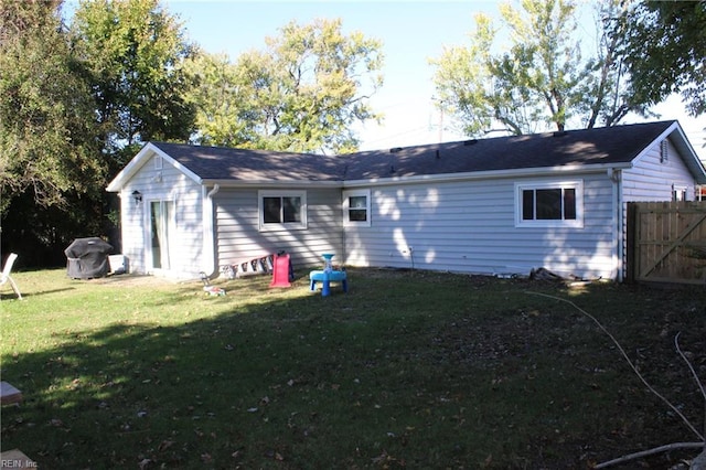 back of house with a lawn