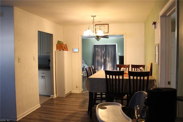 dining area with dark hardwood / wood-style flooring and a notable chandelier