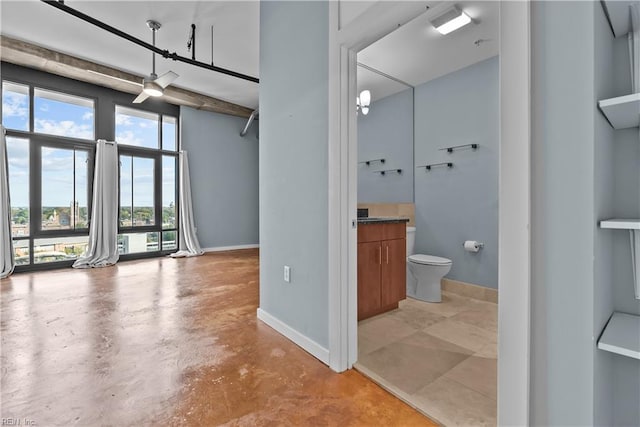 bathroom featuring toilet, concrete flooring, and vanity