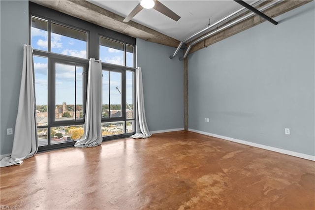 empty room with concrete floors and ceiling fan