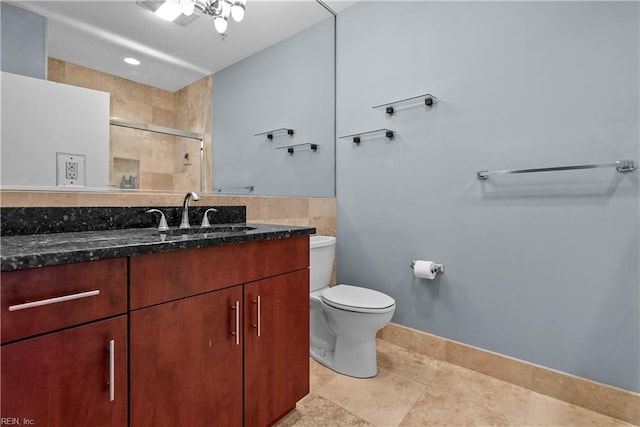 bathroom with vanity, a shower with shower door, and toilet