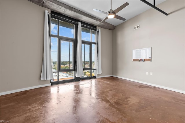 empty room featuring concrete floors and ceiling fan