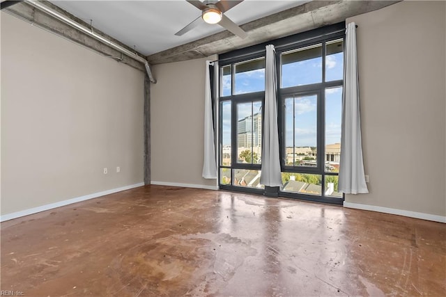 unfurnished room featuring concrete floors, a healthy amount of sunlight, and ceiling fan