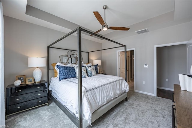 carpeted bedroom featuring ceiling fan, baseboards, and visible vents