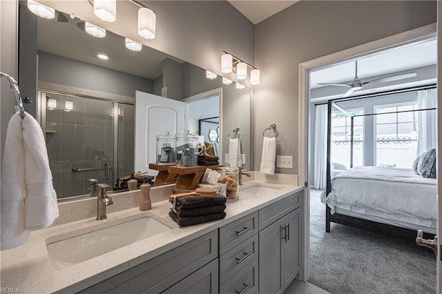 bathroom featuring vanity, a shower with shower door, and ceiling fan