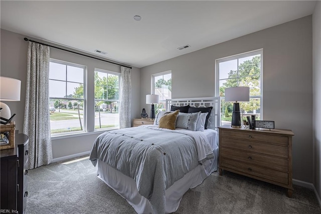 carpeted bedroom featuring baseboards and visible vents