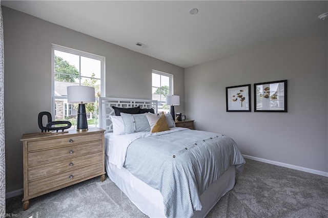 bedroom featuring carpet floors, visible vents, and baseboards