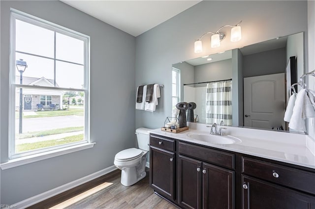 bathroom with vanity, a shower with curtain, hardwood / wood-style flooring, and toilet