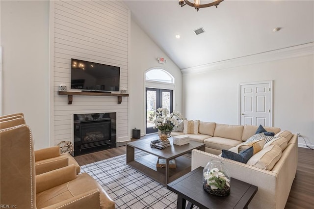 living room featuring dark hardwood / wood-style flooring, high vaulted ceiling, and a fireplace