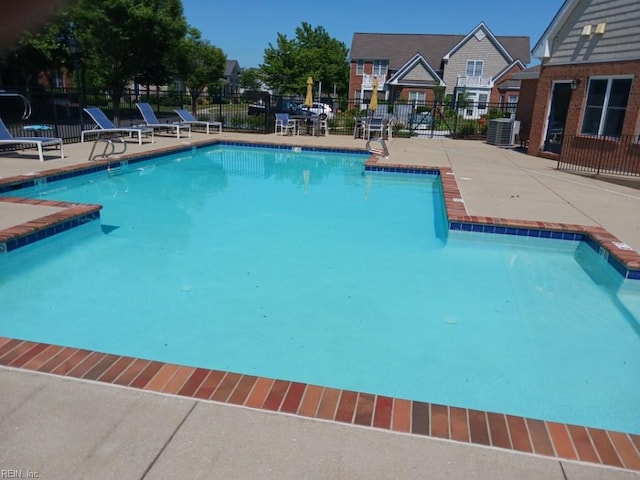 view of pool featuring a patio and cooling unit