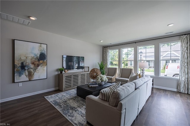 living area with recessed lighting, visible vents, baseboards, and dark wood-style flooring