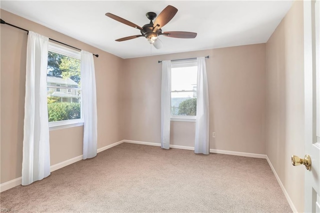 spare room featuring ceiling fan and carpet flooring