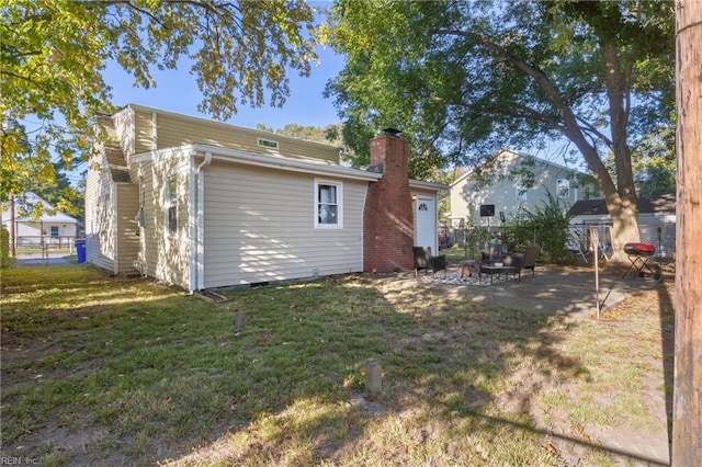 back of house with a yard and a patio area