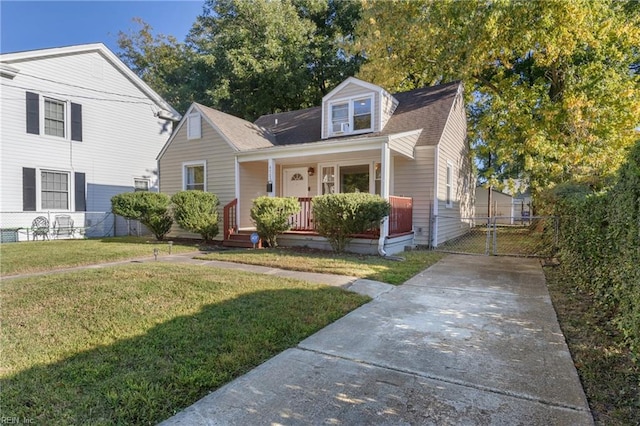 cape cod house with a front yard and a porch