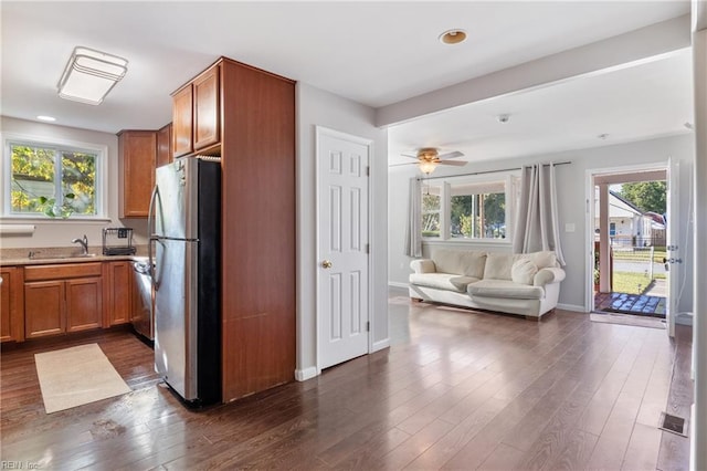 kitchen featuring dark wood-type flooring, appliances with stainless steel finishes, and plenty of natural light