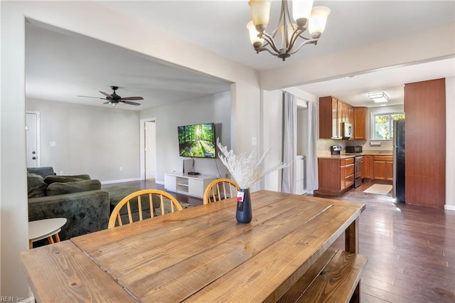 dining space featuring hardwood / wood-style flooring and ceiling fan with notable chandelier